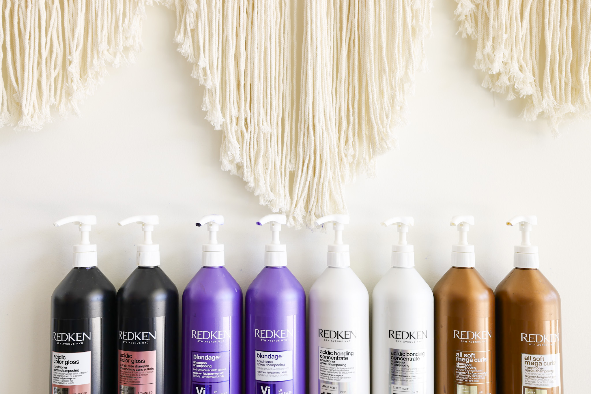 Redken salon product lineup on a shelf — a real brand system in the wild